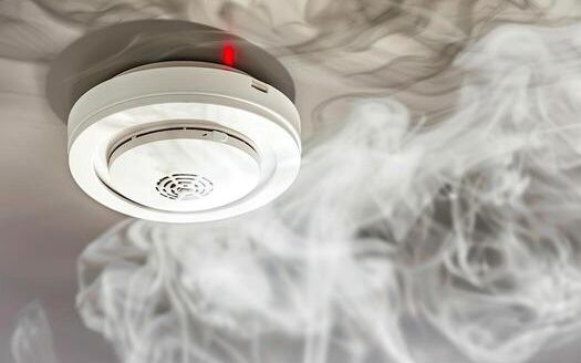 Smoke detector and fire alarm installed on a home ceiling